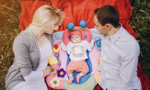 happy-young-parents-looking-their-baby